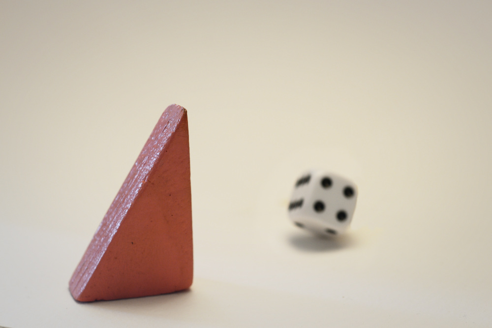 Block Woman looks at a black-and-white die that is being rolled